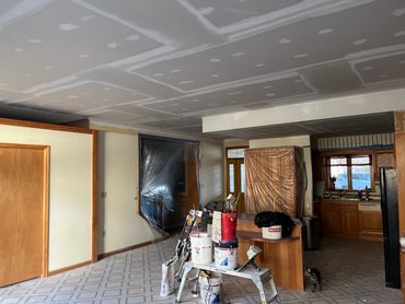 Interior room under renovation with drywall work in progress.