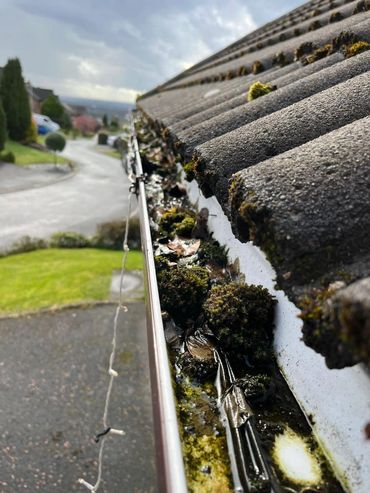 Blocked gutters cleared on a detached property in Bolton. Moss, leaves and debris removed to restore