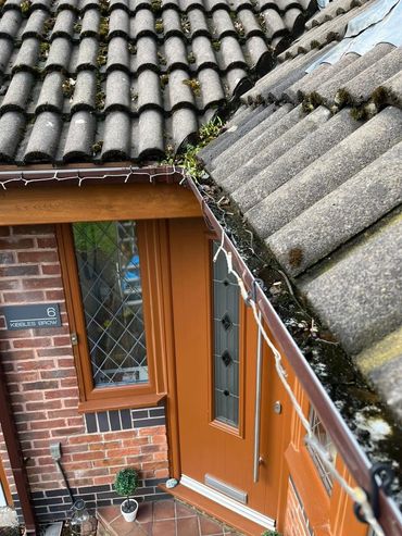 Professional gutter cleaning with visible before and after results on a family home in Greater Manch