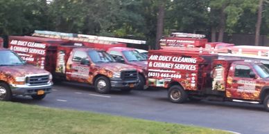 Trucks with vinyl wraps and text "air duct cleaning"