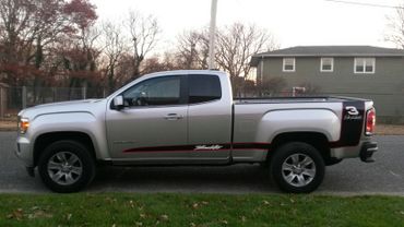A pick-up truck with a black and red side vinyl wrap