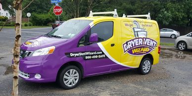 Dryer Vent Wizard's van with a purple and yellow vinyl wrap
