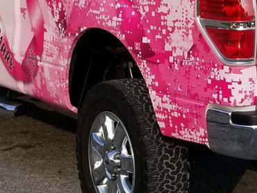 A pick-up truck with breast cancer awareness-themed wrap (backside)