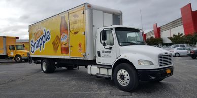 A truck with vinyl wrap design that shows Snapple product