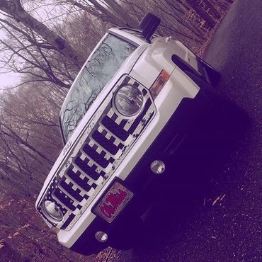 A Hummer with a custom grill skin