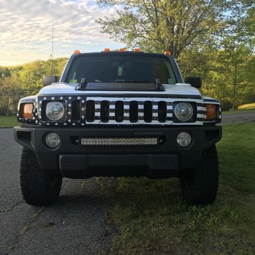 A vehicle with a US flag grill skin