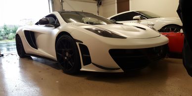 A sports car wrapped in white and black vinyl