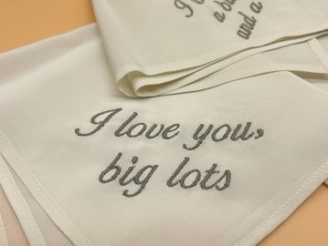 cream handkerchief embroidered with "I love you big lots" in gray