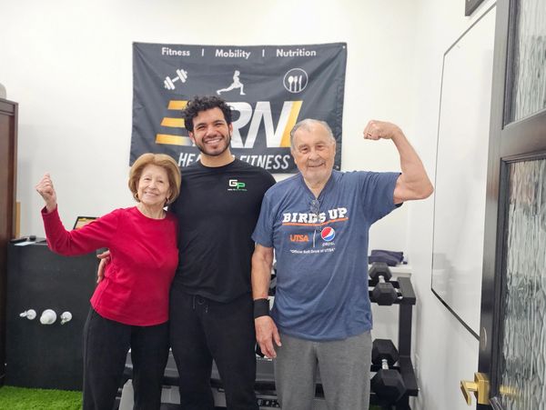 Three generations showing fitness and strength at a gym.