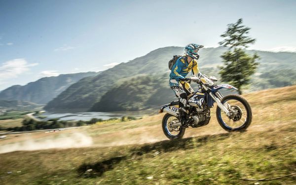 Husaberg FE350 riding through the Carpathian mountains during Redbull Romaniacs