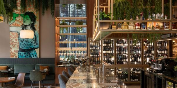 Stylish bar interior with marble countertop and wine display.