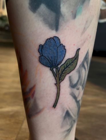 color flower leg tattoo
