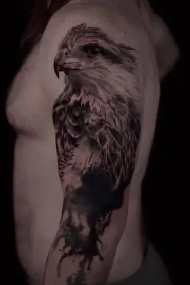 black and gray half sleeve realism tattoo of a hawk with black smeared and dripping ink