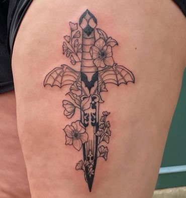 fineline blackwork tattoo of a dagger with bat wigs and flowers