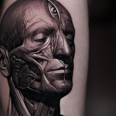 black and gray realism tattoo of anatomical muscle man diagram with a third eye