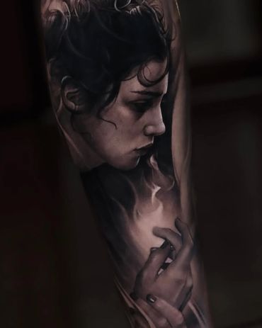 black and gray realism tattoo of a woman with fire