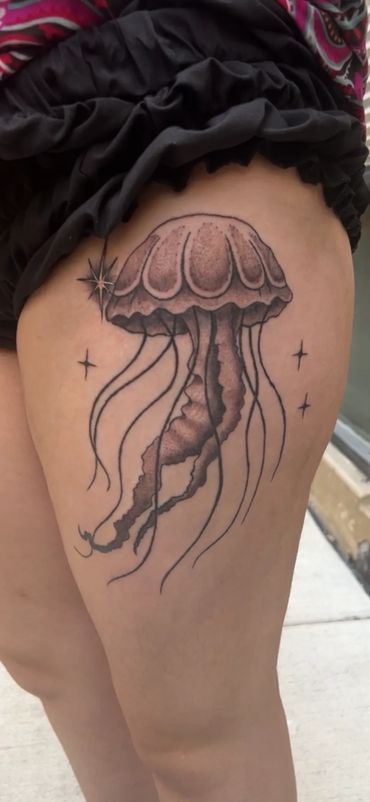 black and grey Jellyfish tattoo on a thigh