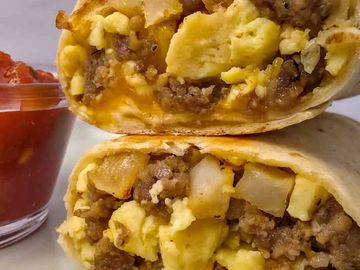 Sausage, Egg, Potato & Cheese break burrito in a flour tortilla
