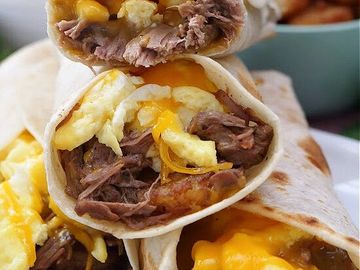 Tender steak scrambled eggs caramalized onions mushrooms jack cheese flour tortilla