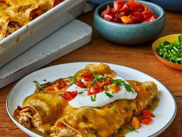 Chicken enchiladas with cheese and enchilada sauce in a flour tortilla
