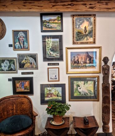 framed paintings on the wall by master artists Diane Binder and master artist Victoria park.