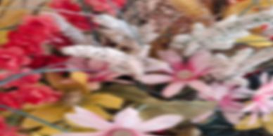 A colorful assortment of flowers with various shades of pink, red, and white.