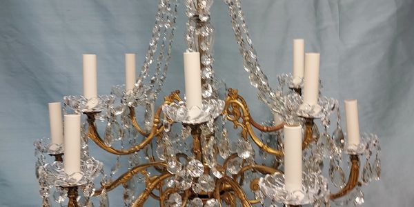 An ornate crystal chandelier with multiple candle-like lights.