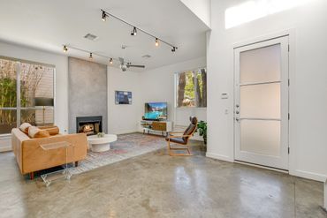 Modern living room with leather sofa and fireplace.