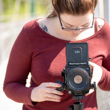 Photographer Caitlin Bevacqua takes a photograph with her vintage 120mm film camera.