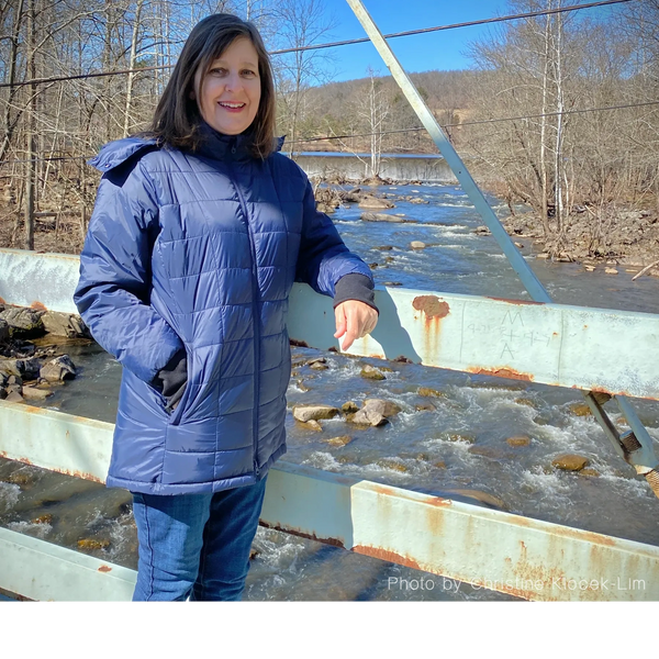 Alexandra Wisser on a bridge by the stream