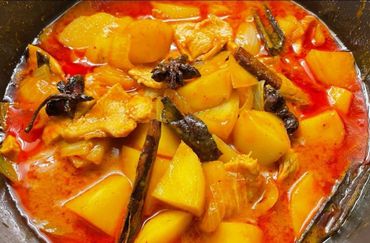 A rich, spicy stew with potatoes, chicken, and whole spices like cinnamon and star anise.