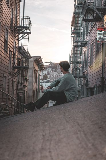 Reinert Webb Sitting Surrounded by Buildings