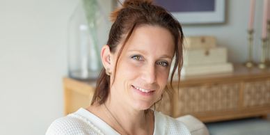 Smiling woman in a cozy home setting.