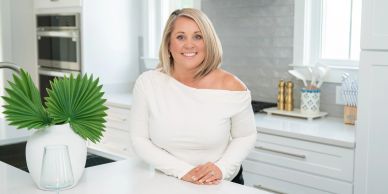 Woman smiling in a modern kitchen.