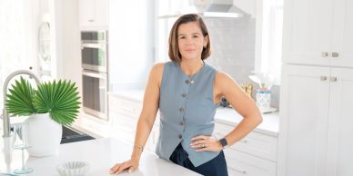 Woman standing confidently in a modern kitchen.