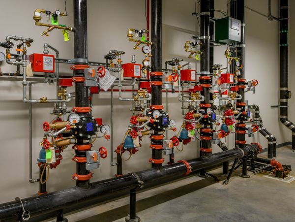 A series of interconnected fire protection valves and pipes, featuring gauges and control panels