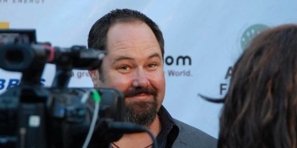 Man smiling at a camera during an interview.