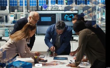 Team of engineers collaborating on a technical project in a modern workspace.