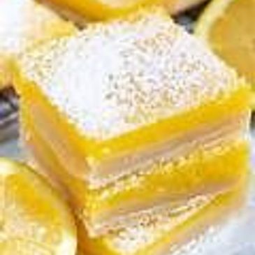 Stack of lemon bars dusted with powdered sugar.