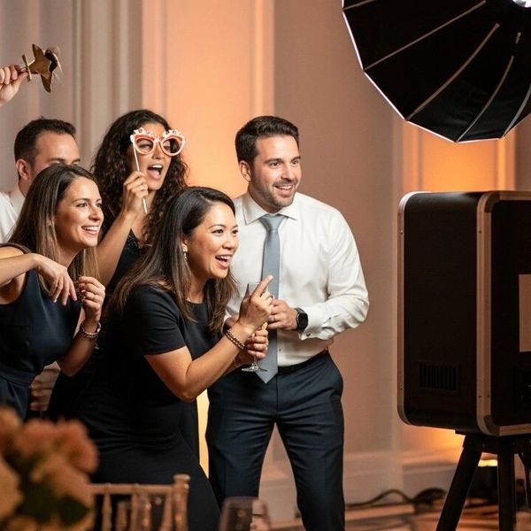 Group of friends enjoying a photo booth at a party.