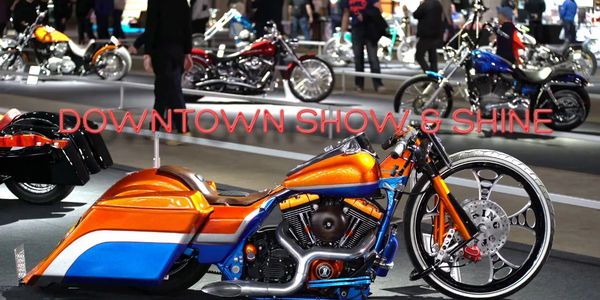 Custom orange and blue motorcycle showcased at Downtown Show & Shine event.