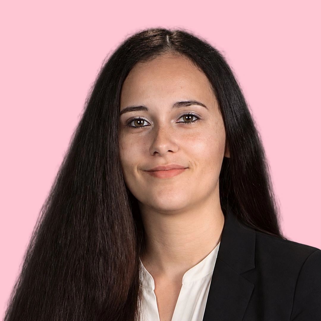 Professional woman with long dark hair and a friendly smile.