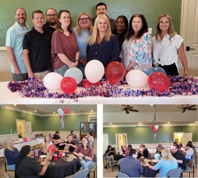 Group celebrating with balloons and decorations indoors.