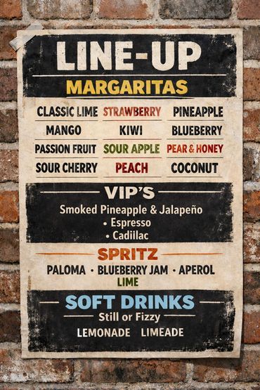 Vintage-style menu of margaritas, VIP cocktails, spritz, and soft drinks on a brick wall.