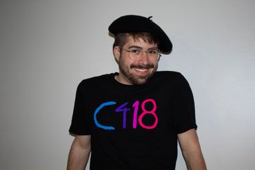 A photograph of myself smiling at the camera while wearing a beret and my "C418" shirt.