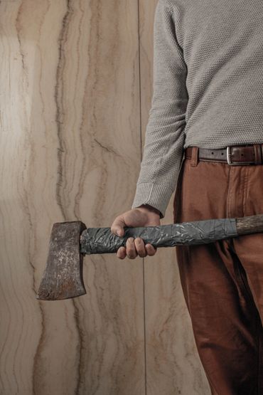 A mid-body photograph of myself holding a rusty axe. It's a very "horror movie poster" looking shot.