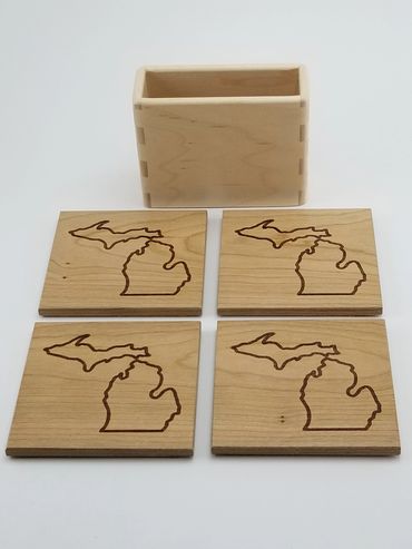 Set of drink coasters in hard maple with Michigan outline.  Container has box jointed corners