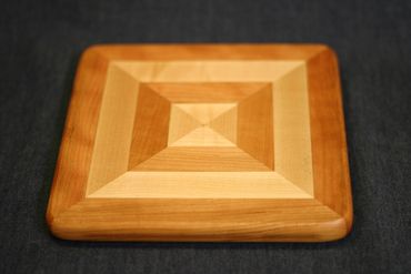 Trivet or charcuterie board in cherry and hard maple