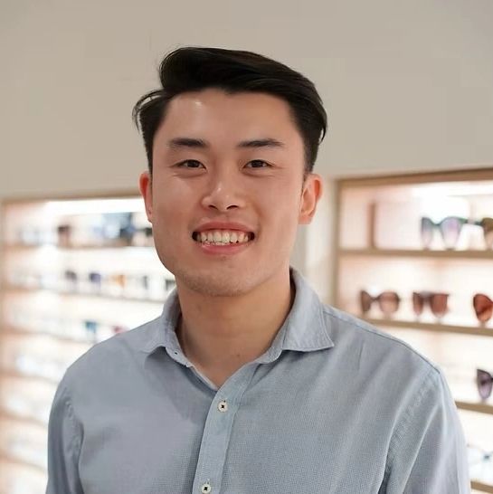 Young man smiling in an eyewear store.