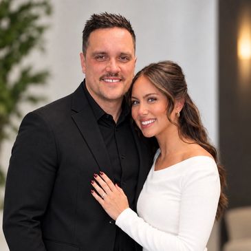 Smiling couple posing for a photo indoors.